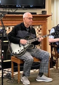 Image of Don Bradford, a musician playing his guitar